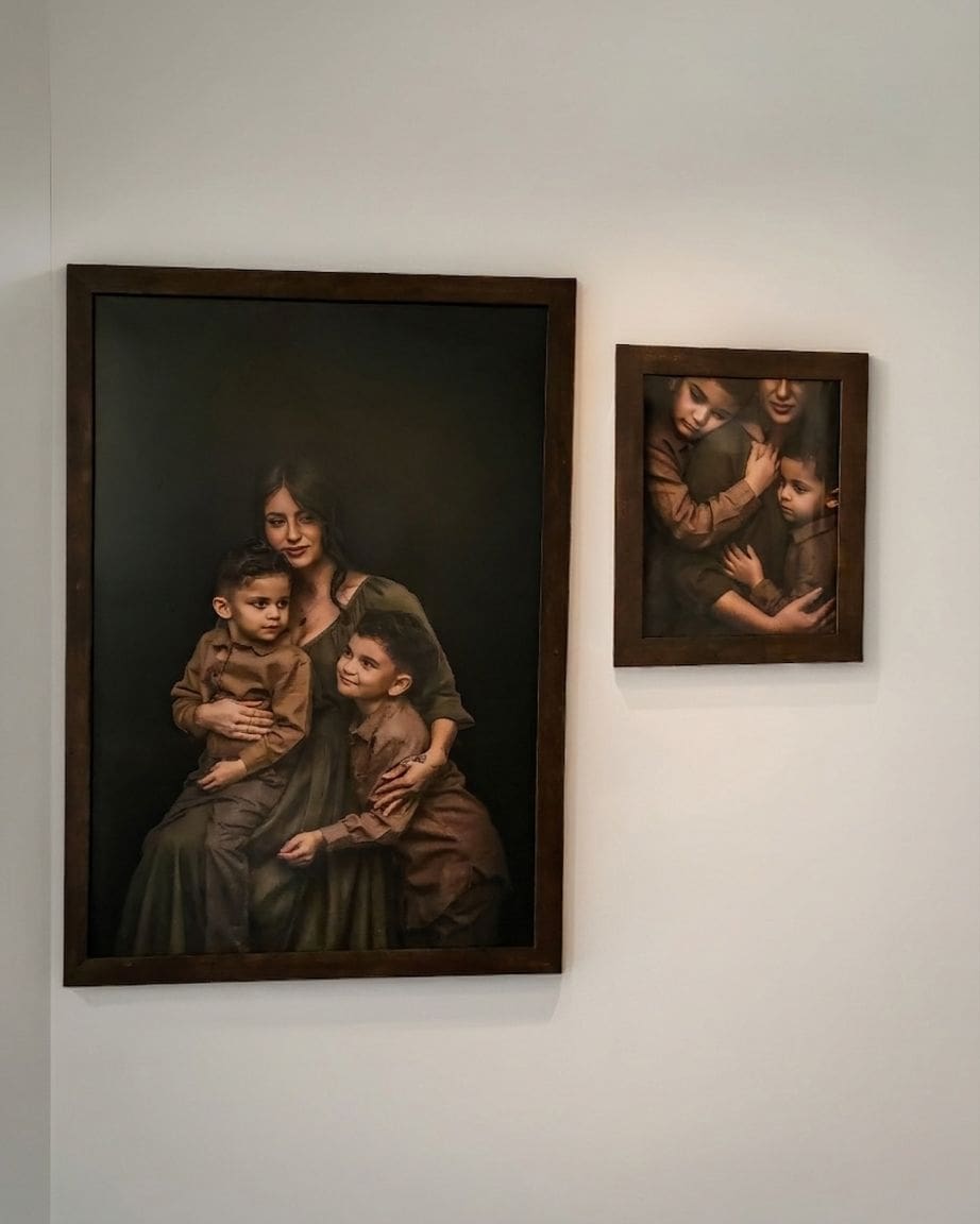Two framed heirloom family portraits hanging on a wall, showcasing museum-quality fine art photography in Odessa, Texas.