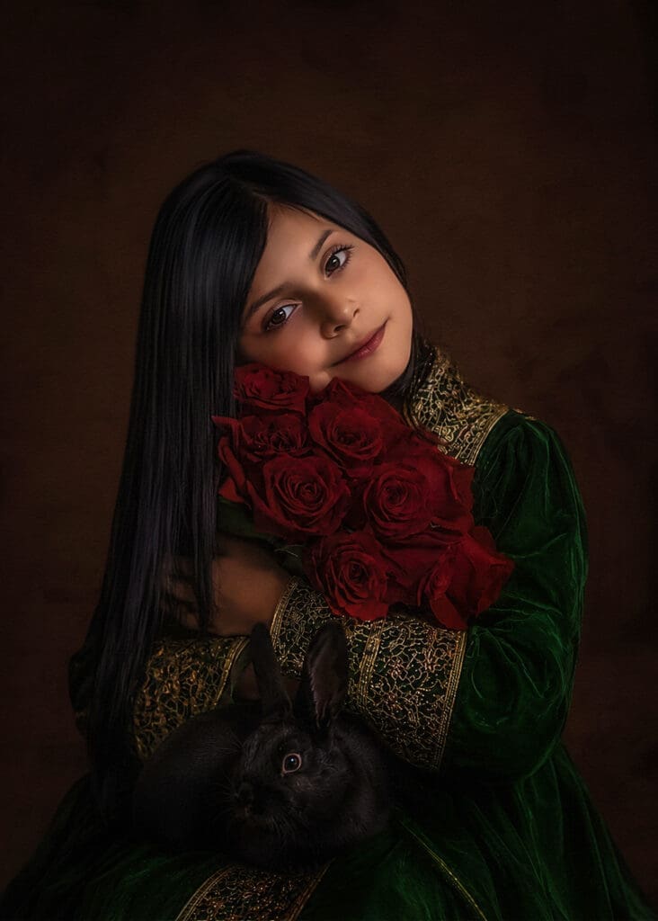 Fine art child portrait in Odessa Texas by Jeanette Sebolt Fine Art featuring a young girl holding red roses and a black bunny