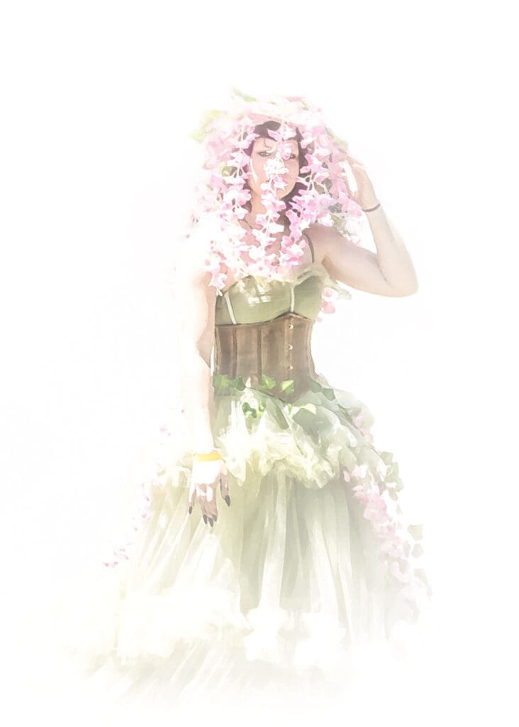 Woman in a fairy-inspired floral costume with pink flowers and green clothing at the West Texas Renaissance Festival in Odessa, Texas.